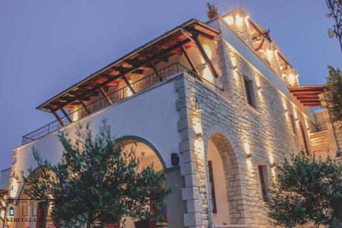 a building with lights on the side of it at KERCULLA Resort in Gjirokastër