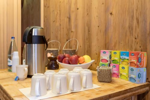 a counter with a coffee maker and a bowl of apples at Hotel Nordik in Santa Caterina Valfurva