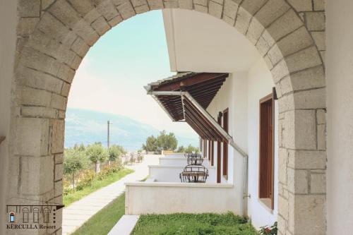 an archway on a building with a view of a road at KERCULLA Resort in Gjirokastër