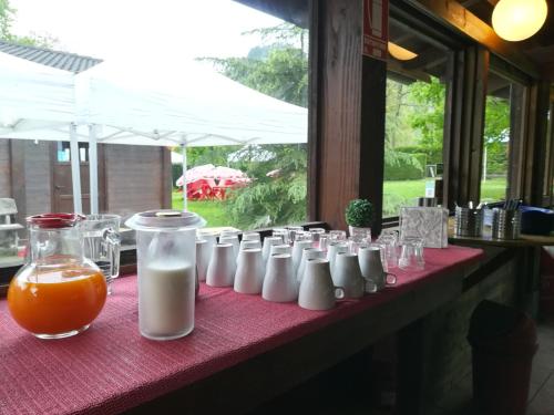 a red table topped with milk and orange juice at Stura River Village RAFTING in Gaiola