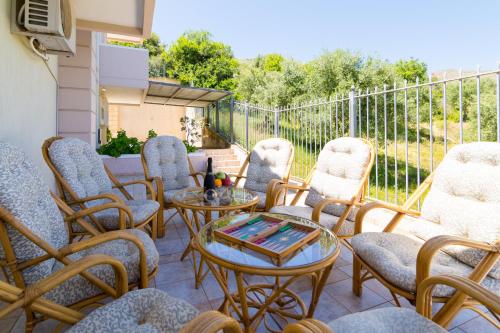 a group of chairs and tables on a patio at Aris Palace in Elia