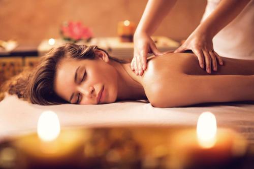 a woman getting a massage in a spa tub at Park Regis Lotus Hotel in Manama