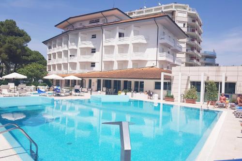 a large swimming pool in front of a building at Hotel Bristol in Lignano Sabbiadoro