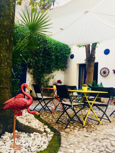 a red flamingo standing on a rock path in a garden at B&B La Corte in Chioggia