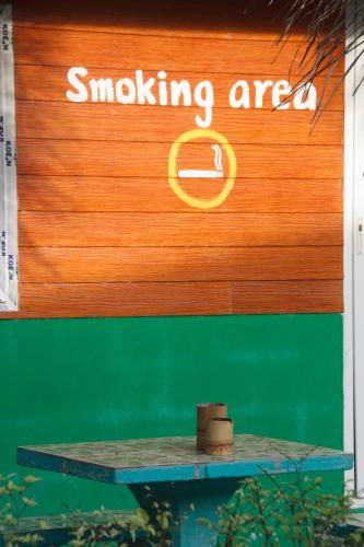 a sign that says smoking area with a table in front of it at Khao Sok Palmview Resort in Khao Sok