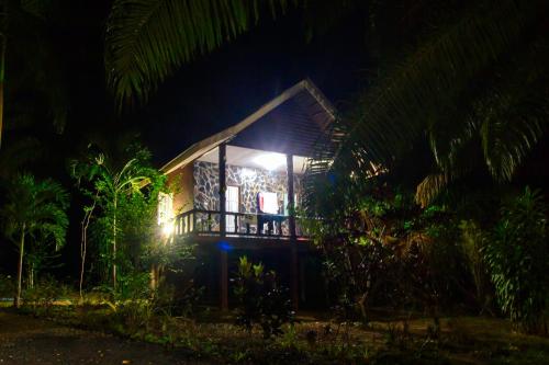 a small house with a light at night at Khao Sok Palmview Resort in Khao Sok