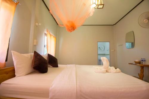 a bedroom with a bed with two towels on it at Khao Sok Palmview Resort in Khao Sok