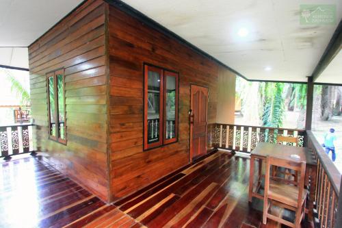 a room with a wooden wall in a house at Khao Sok Palmview Resort in Khao Sok