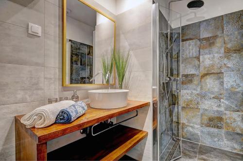 a bathroom with a sink and a shower at Vista center Apartment in Pula