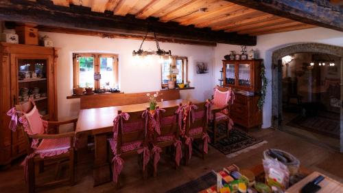 a kitchen with a dining room table with pink chairs at Biohof Hausberg in Egglham