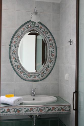 a bathroom with a sink and a mirror at Makedos Sea View in Nea Vrasna
