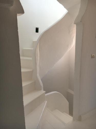 a white staircase with a white stair case at Dar Said in Asilah