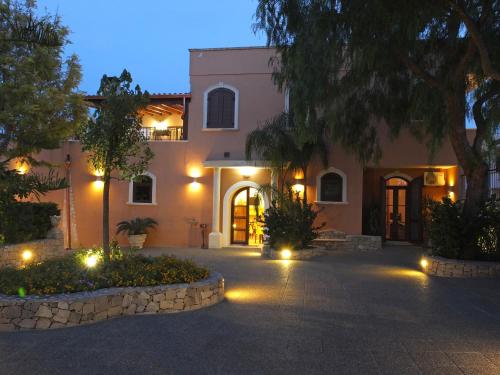 a house with lights in front of it at night at Villa Musica in Sannicola