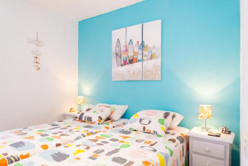 コラレホにあるMarina House Corralejo Centerの青い壁のベッドルーム1室(ベッド1台付)