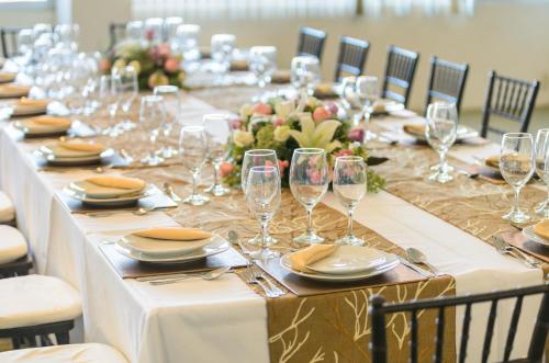 a long table with wine glasses and plates on it at Hotel San Francisco Leon in León