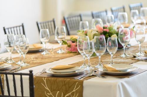 a long table with wine glasses and plates on it at Hotel San Francisco Leon in León