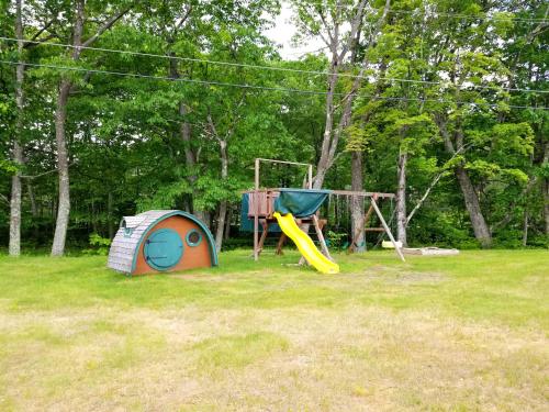a tent and a playground in a field at The Lodge at Jackson Village in Jackson