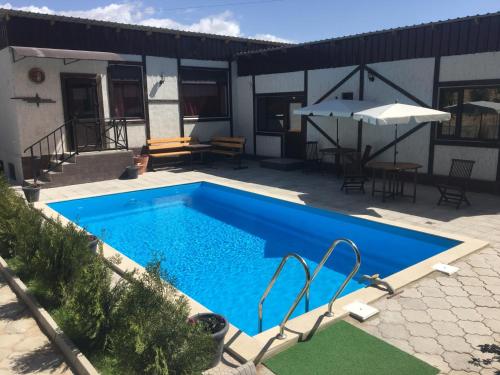 a large blue swimming pool next to a building at Evropa Hotel in Bosteri