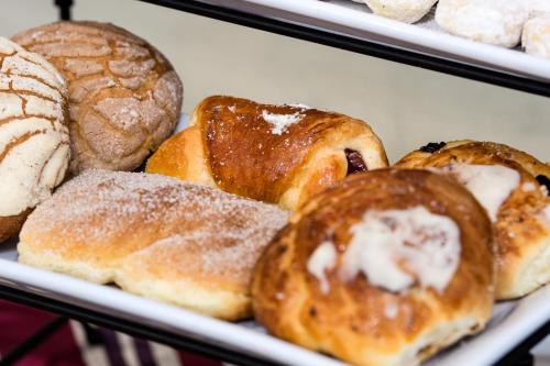 a bunch of different types of pastries on a plate at Hotel San Francisco Leon in León