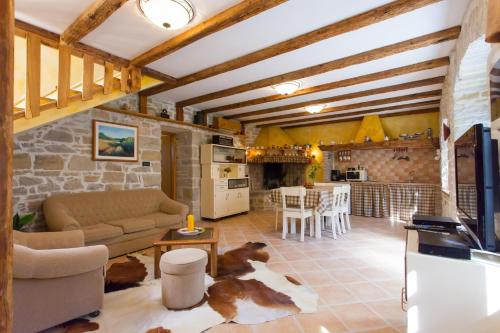 a living room with a couch and a table at Villa Franz Krbune in Potpićan