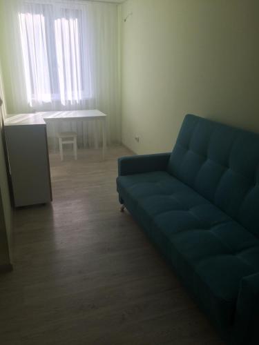 a living room with a blue couch and a table at Mega city in Kyiv