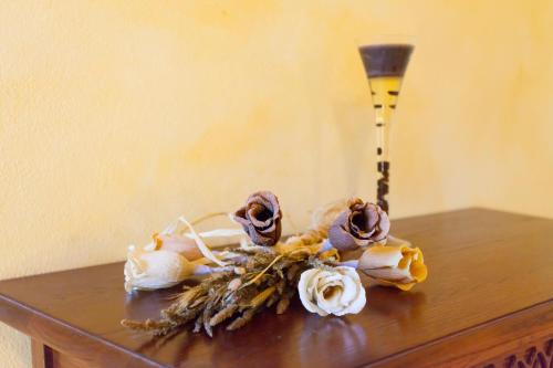 a table with a vase and flowers on it at Villa Franz Krbune in Potpićan
