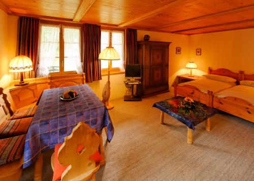 ein Schlafzimmer mit einem Bett und einem Tisch darin in der Unterkunft Chalet Unter dem Stein in Grindelwald
