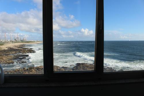 a view of the ocean from a window at Matosinhos -Seas Apartment- Cabo das Marés in Matosinhos