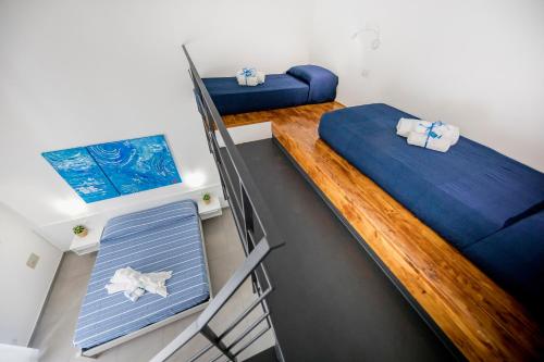 two beds in a small room with a ladder at Pepito palace in Cefalù