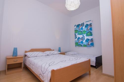 1 dormitorio con 1 cama y una pintura en la pared en Elida, en Krk