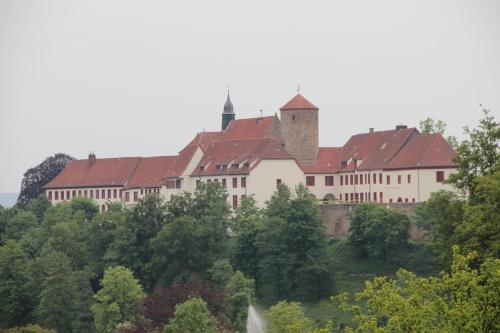 a large building on top of a hill with trees at Gasthaus Wiemann-Sander in Bad Iburg