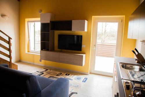 a living room with a tv on a wall at Gate To Verona in Verona