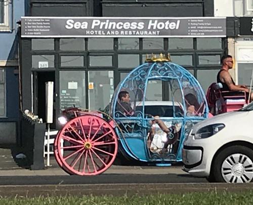 a man riding in a horse drawn carriage at Sea Princess Hotel Blackpool in Blackpool