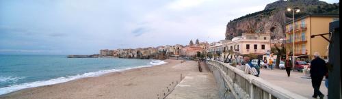 a view of a beach with buildings and the ocean at Pepito palace in Cefalù