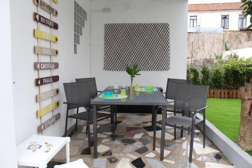 a patio with a black table and chairs at Porto In Sight, 4 Kids in Vila Nova de Gaia