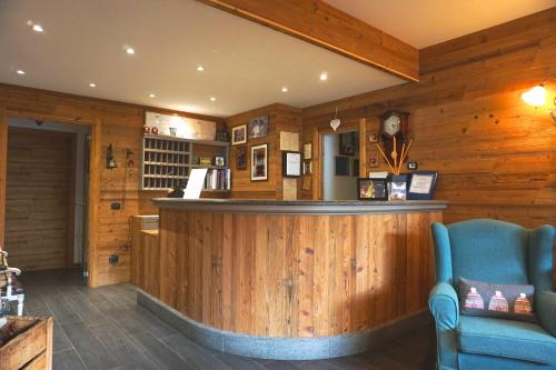 a bar in a room with wooden walls at Olimpia Hotel in Bormio