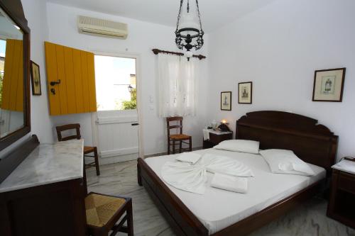 a bedroom with a bed and a table and chairs at Ostria in Naousa