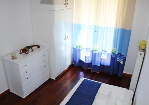 En eller flere senge i et værelse på Villa Antonia