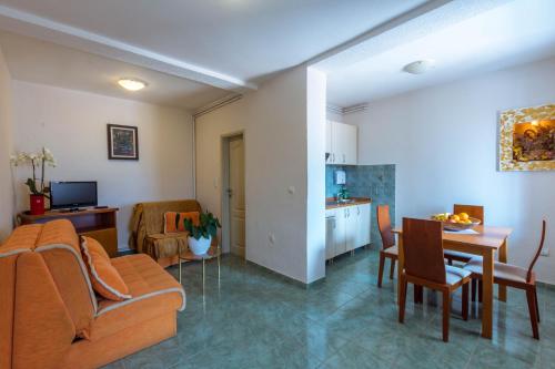 a living room with a couch and a table at Contessa Apartments in Budva