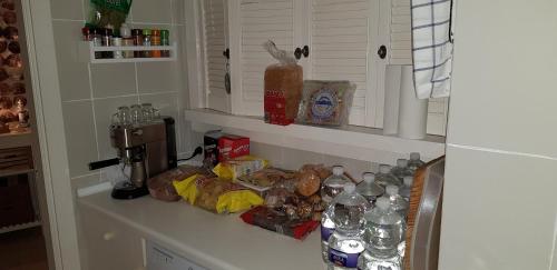 een aanrecht vol met etenswaren en waterflessen bij Malva Loca Apartment in Benalmádena