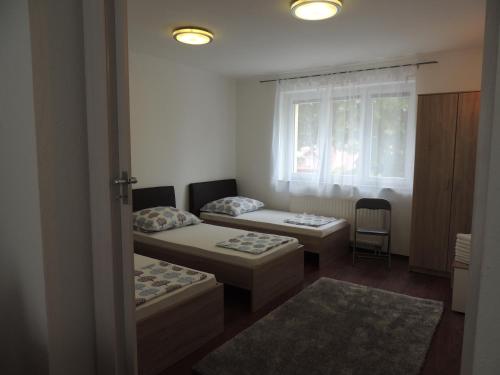 a room with two beds and a window at Roses in Bihać