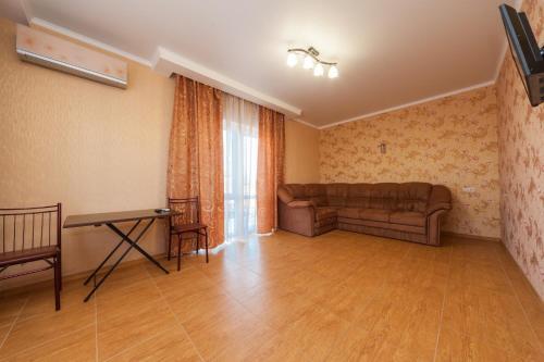 a living room with a couch and a table at Villa Orchidea in Zatoka
