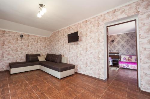 a living room with a couch and a mirror at Villa Orchidea in Zatoka
