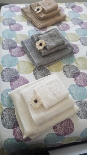 a table topped with towels on a patterned table at Giuly home two in Càbras