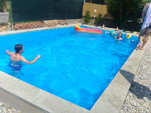 a group of children playing in a swimming pool at Holiday Home ZEN in Fažana
