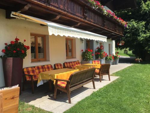 a table and chairs in front of a house at Oberhub am Kleinsonnberg in Taxenbach