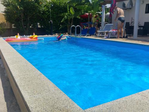 a woman is playing in a swimming pool at Holiday Home ZEN in Fažana