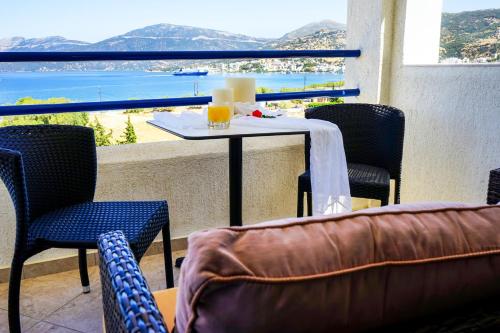 a table and chairs on a balcony with a view of the ocean at Alykes in Marmarion