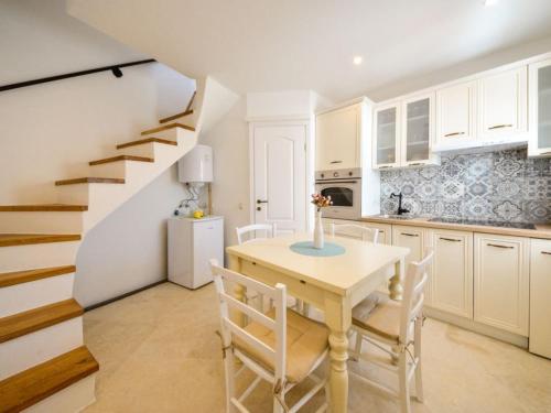 a kitchen with a table and chairs and a staircase at Lavender in Baška