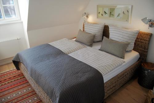 a bedroom with a bed with pillows and a mirror at Claras Strandhuus in Zingst
